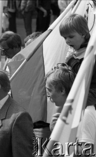 1.05.1986, Warszawa, Polska.
Pochód pierwszomajowy, dziecko na ramionach ojca.
Fot. Jarosław Tarań, zbiory Ośrodka KARTA [86-60] 
