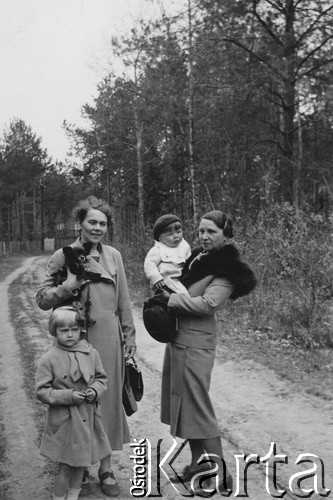 Jesień 1938, prawdopodobnie Zalesie koło Warszawy, Polska.
Wacława Jekiel trzyma na ręku pieska, obok roczny Wojtuś na rękach cioci Tosi, żony wuja Sławomira  Rodziewicza.
Fot. NN, zbiory Ośrodka KARTA, udostępniła Anna Równy
  
