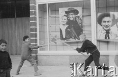 1960, Warszawa, Polska.
Chłopcy bawiący się przed kinem Skarpa. W tle fotosy z filmu 