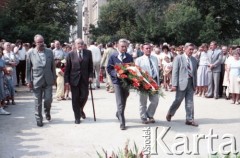 1985, Warszawa, Polska.
Uroczystości związane z odsłonięciem pomnika Ignacego Jana Paderewskiego w nowym miejscu - w Parku Ujazdowskim. Odlana z brązu rzeźba projektu Michała Kamieńskiego od 1978 ustawiona była przy ul. Okólnik, w sąsiedztwie Pałacu Ostrogskich i Państwowej Wyższej Szkoły Muzycznej. W 1985 roku pomnik przeniesiono i ustawionio w nowej lokalizacji, naprzecikwo wejścia do Parku Ujazdowskiego. Na zdjęciu uczestnicy uroczystości składają wieniec pod pomnikiem.
Fot. Edward Grochowicz, zbiory Ośrodka KARTA.