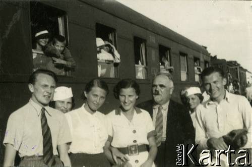 Lato 1938, Jastarnia lub Gdynia, woj. pomorskie, Rzeczpospolita Polska.
Larysa Zajączkowska (3. z lewej) stoi na peronie przed pociągiem. W pierwszym oknie pociągu widoczna jej matka Elżbieta oraz brat Jerzy. 
Fot. NN, kolekcja Larysy Zajączkowskiej-Mitznerowej, zbiory Ośrodka KARTA
