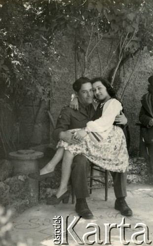 1945, Dicomano, Włochy.
Silvia Szymula z domu Valli i Stefan Szymula. S. Szymula przed wojną pracował w Powiatowym Zarządzie Drogowym w Buczaczu, po 1939 ukrywał się. Aresztowany po nieudanej ucieczce do Rumunii, osadzony w więzieniu w Czortkowie, później w Starobielsku. Skazany na 5 lat obozu, zesłany w styczniu 1941 roku na Syberię. Dostał się do Armii Andersa, z którą został ewakuowany do Iranu. Przeszedł z nią cały szlak bliskowschodni. W Palestynie ukończył Szkołę Podchorążych Piechoty Rezerwy i został mianowany porucznikiem. Walczył pod Monte Cassino. W 1948 roku emigrował z żoną i synkiem do Argentyny. Nz. Silvia w stroju ludowym stylizowanym na polski, który sama uszyła.
Fot. NN, zbiory Silvii Szymuli, reprodukcje cyfrowe w  Bibliotece Polskiej im. Ignacego Domeyki w Buenos Aires (Biblioteca Polaca Ignacio Domeyko) i w Ośrodku KARTA w Warszawie