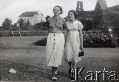 Przed 1939, Nowogródek, Polska.
Antonina Bułat (z lewej), matka Oktawii Pietuchowskiej, z koleżanką. W tle ruiny zamki Mendoga, z lewej kościół farny (